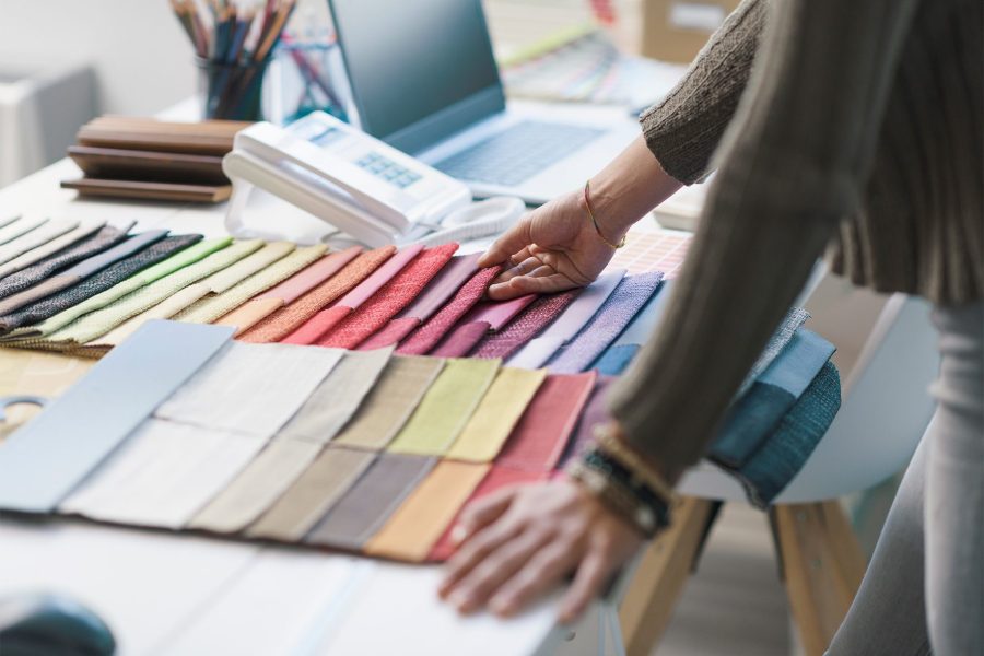 professional-decorator-choosing-fabric-swatches-2022-01-19-00-21-44-utc
